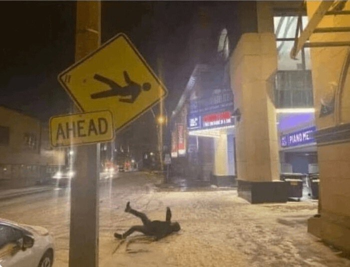 a car is parked on the street in the snow